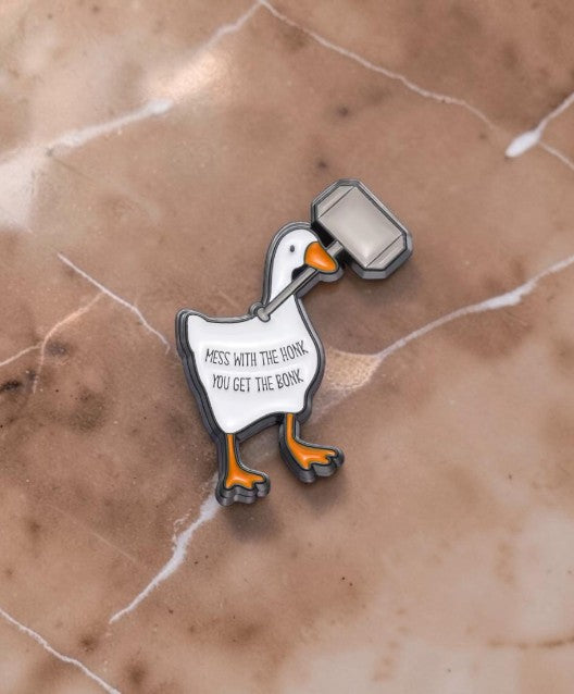 Pins & Co. enamel lapel pin featuring a white goose holding a grey hammer with the text Mess with the honk you get the bonk