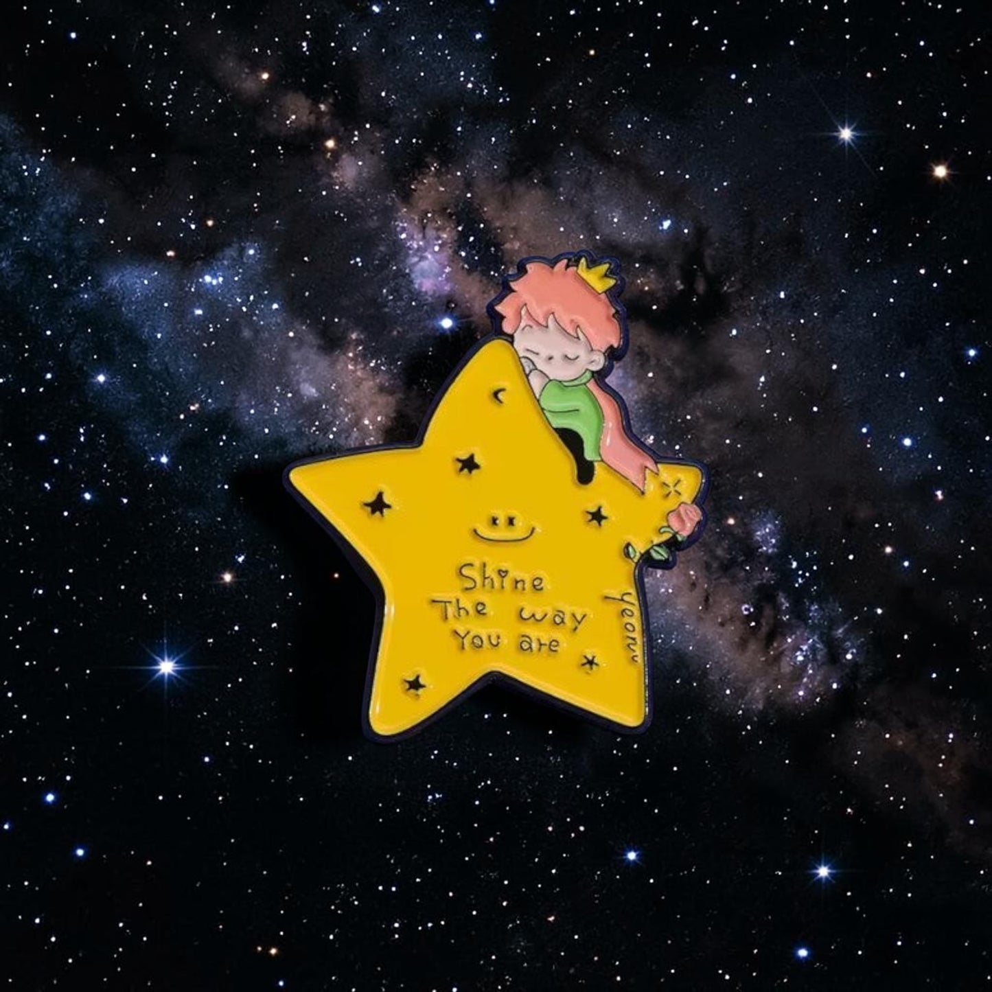 Pins & Co. enamel pin featuring the Little Prince sleeping on a yellow star with a rose and inspirational text.