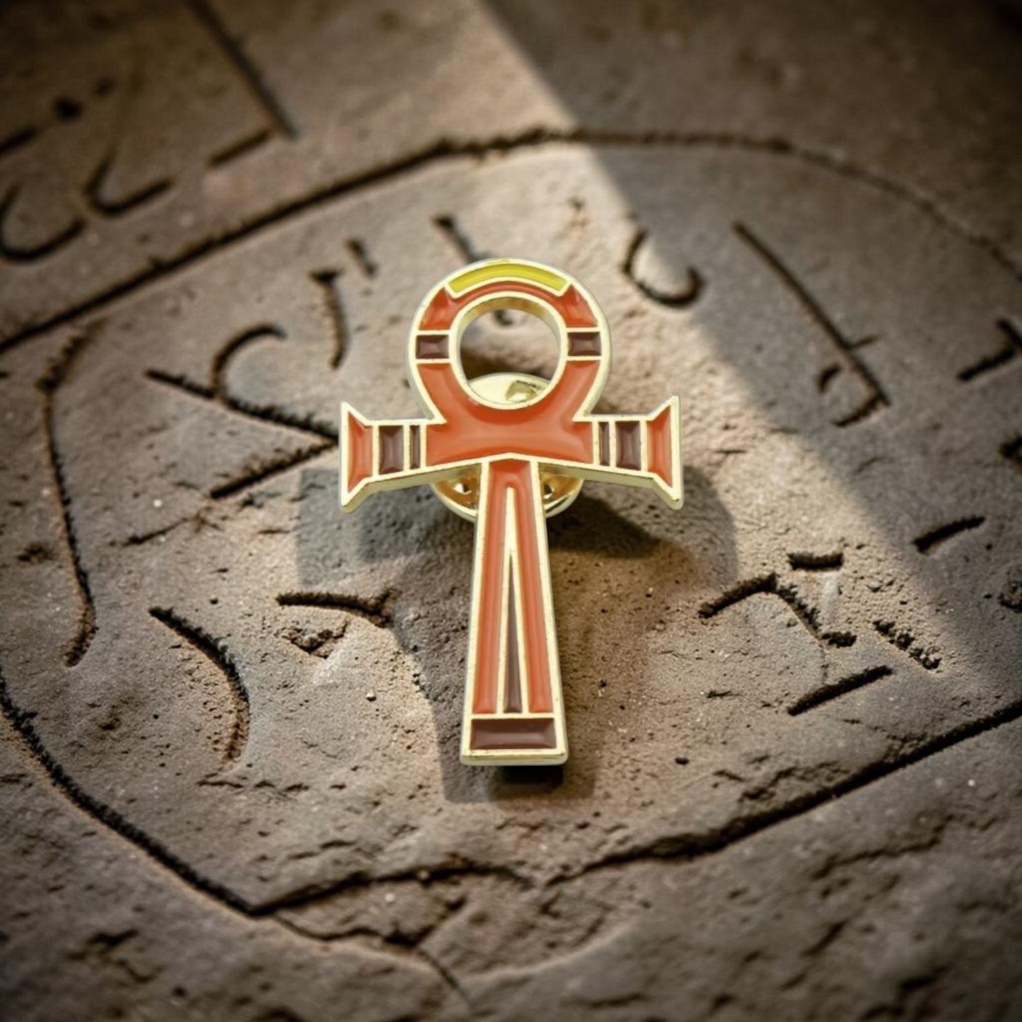 Pins & Co. Ankh enamel lapel pin in gold-tone with vibrant orange and brown detailing, Egyptian cross symbol.