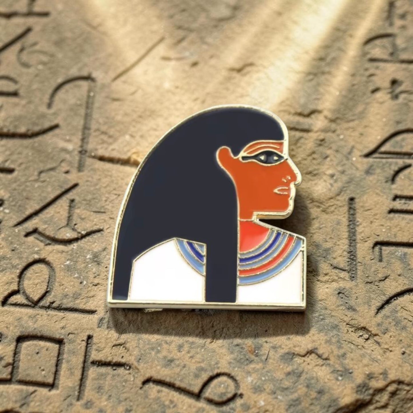 Pins & Co. Egyptian Queen enamel pin featuring a profile of a pharaonic figure with gold-tone metal and vibrant colors.