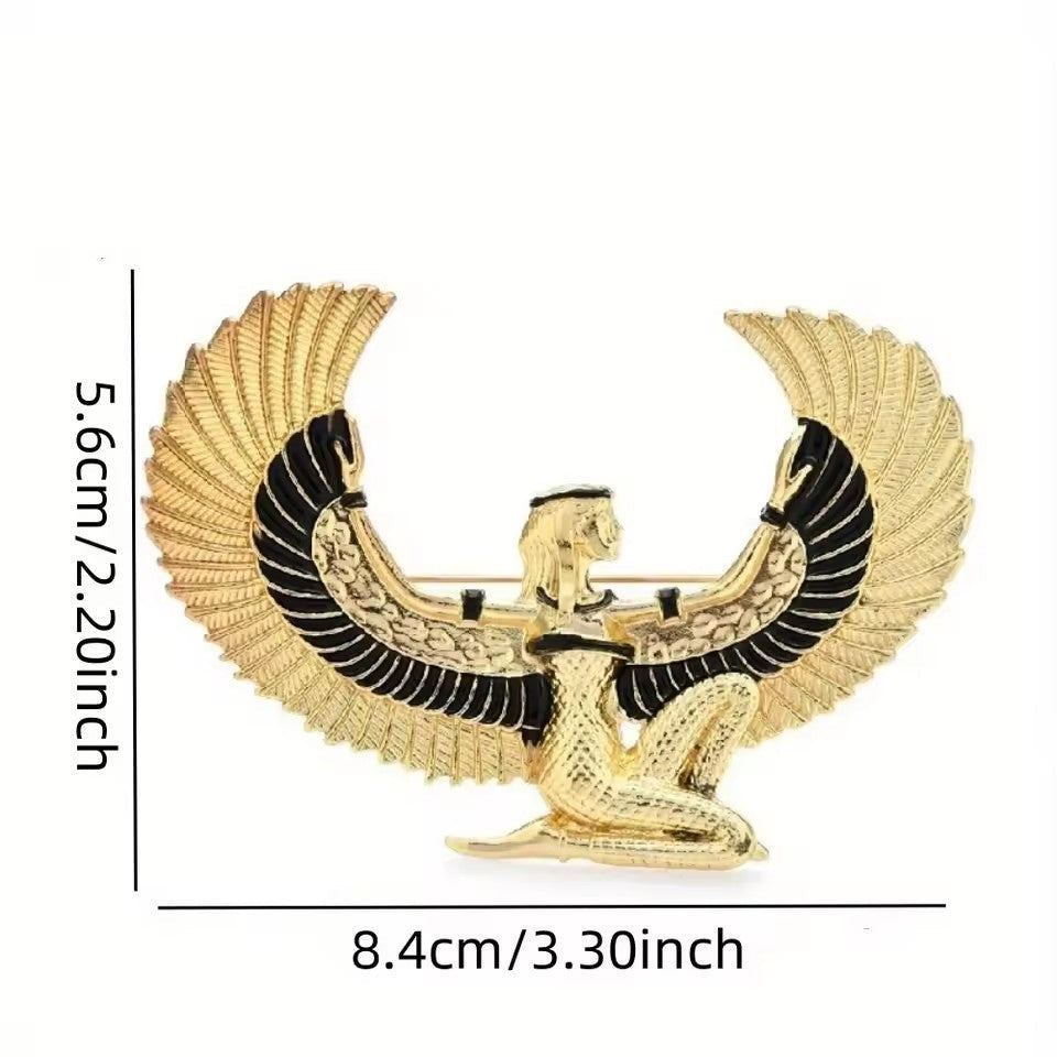 Pins & Co. gold-tone Egyptian winged goddess brooch with black enamel accents and intricate wing detailing.
