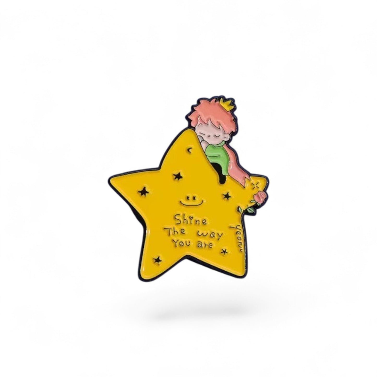Pins & Co. enamel pin featuring a little prince sleeping on a yellow star with a rose and the text Shine The way You are